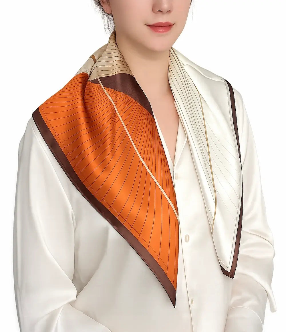 YANOVA 26.4 × 26.4 in (67 × 67 cm) 100% Mulberry Silk Square Scarf in Caramel Flow geometric pattern, styled as an elegant women’s neck scarf in ivory, caramel, and brown.