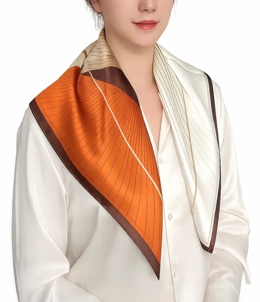 YANOVA 26.4 × 26.4 in (67 × 67 cm) 100% Mulberry Silk Square Scarf in Caramel Flow geometric pattern, styled as an elegant women’s neck scarf in ivory, caramel, and brown.
