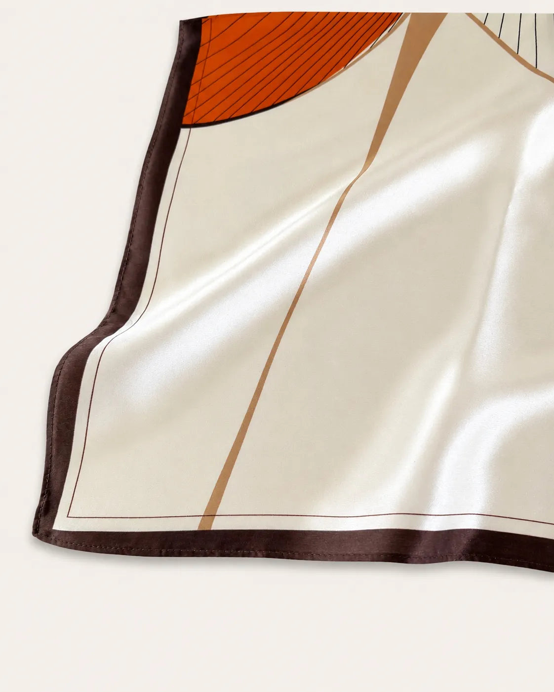 Close-up of the YANOVA 100% Mulberry Silk Square Scarf, showcasing the smooth silk texture, hand-rolled edges, and Caramel Flow geometric pattern.