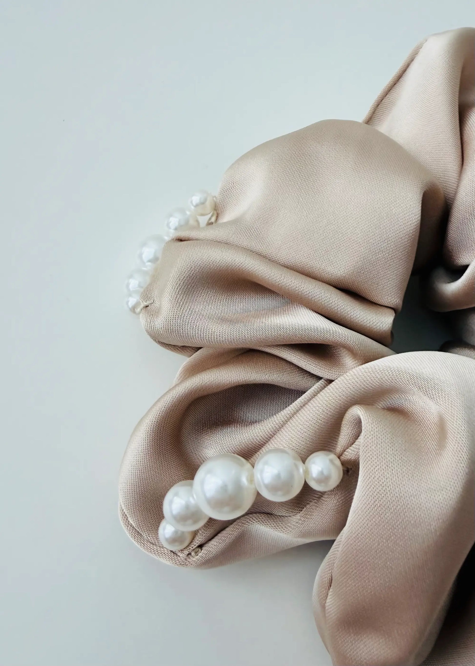 ⁠Close-up detail of the premium satin fabric and hand-stitched faux pearls on YANOVA hair accessory.⁠